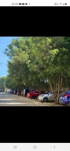 a row of cars parked in a parking lot with trees at Cagayan de Oro City Transient Near Polymidec Medical Plaza in Cagayan de Oro