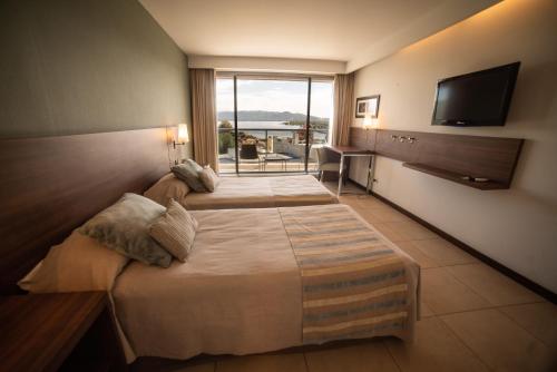 Postel nebo postele na pokoji v ubytování Hotel Estilo MB - Villa Carlos Paz