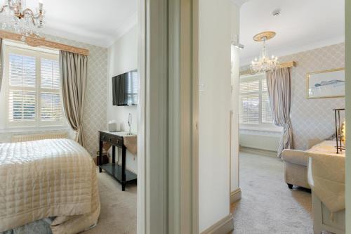 a bedroom with a bed and a desk in a room at The Somerville in Torquay