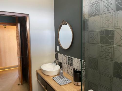 a bathroom with a sink and a mirror at Lekkerberg in Riebeek-Kasteel