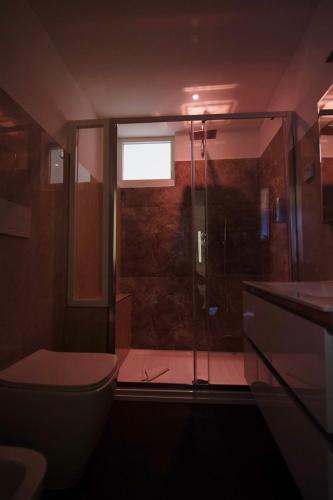 a bathroom with a shower and a toilet and a sink at Dream B&B Roma in Rome