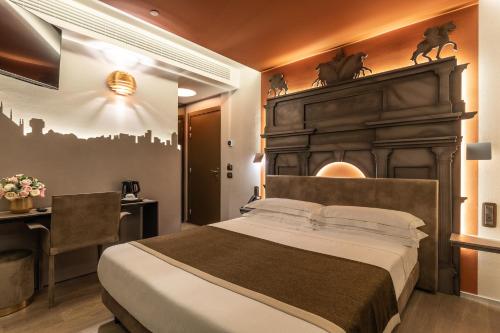 a bedroom with a large bed and a desk at Hotel Ariston in Milan