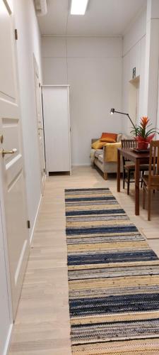 a living room with a rug on the floor and a table at Good Life Homestay in Ahmovaara