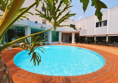 a large blue pool in front of a building at Biss Inn Hotel in Goiânia