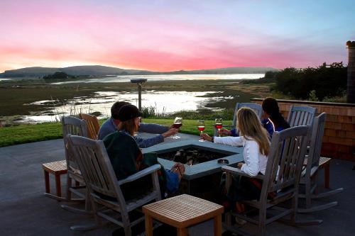 a group of people sitting around a table drinking wine at The Lodge at Bodega Bay in Bodega Bay