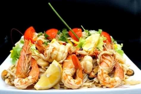 a plate of food with shrimp and vegetables on it at Balule Bushveld Safari Lodge in Phalaborwa