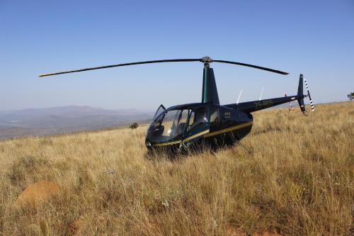 a helicopter sitting on top of a grassy hill at Balule Bushveld Safari Lodge in Phalaborwa