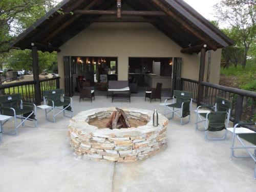 a patio with chairs and a fire pit at Balule Bushveld Safari Lodge in Phalaborwa