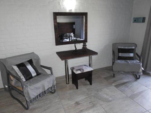 a room with a table and a chair and a mirror at Balule Bushveld Safari Lodge in Phalaborwa