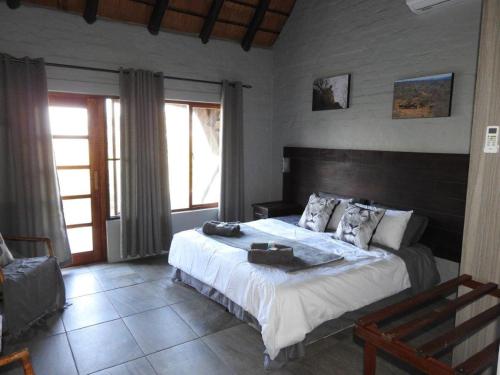 a bedroom with a large bed in a room at Balule Bushveld Safari Lodge in Phalaborwa