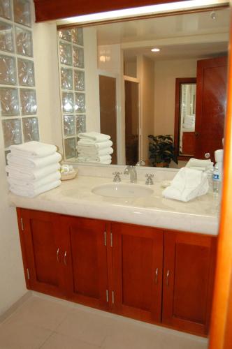 a bathroom with a sink and a mirror at Real de Minas San Luis Potosi in San Luis Potosí