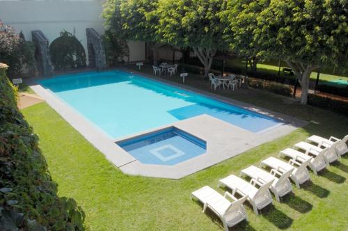 an overhead view of a swimming pool with white lounge chairs at Real de Minas San Luis Potosi in San Luis Potosí