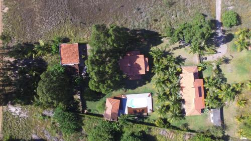 an overhead view of a house with trees and bushes at Mangaba Village in Barra Grande