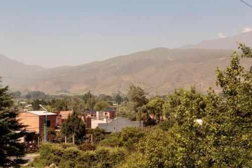 a small town with mountains in the background at Los Abuelos Departamentos in Tafí del Valle