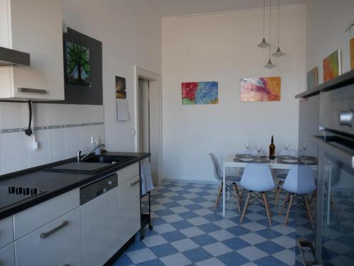 een keuken met een spoelbak en een tafel met stoelen bij Ferienwohnungen in der Kunstgalerie in Chemnitz
