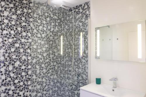 y baño con ducha y lavamanos. en Magnifique appartement, en hyper centre, avec terrasse et place de parking en Biarritz