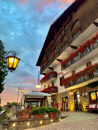 a building with flower boxes on the side of it at Aurora in Castione della Presolana
