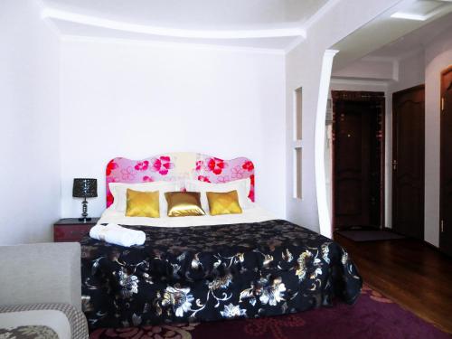 a bedroom with a large bed with a red headboard at Bestshome Apartments in Bishkek