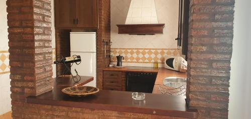 a kitchen with a counter top and a refrigerator at Alojamiento Rural el Respiro "Calma" in Benaocaz