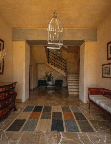 a large room with a staircase and a chandelier at Finca Gomera - Agroturismo Hotel in Cala Pi
