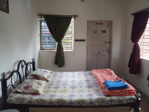 a bedroom with a bed and a window at We have wonderful villa at Shantiniketan. in Shānti Niketan