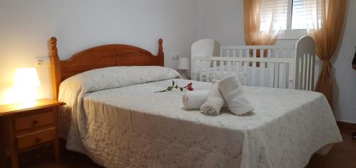 a bedroom with a bed with two towels on it at Alojamiento Rural El Respiro "Brisa" in Benaocaz
