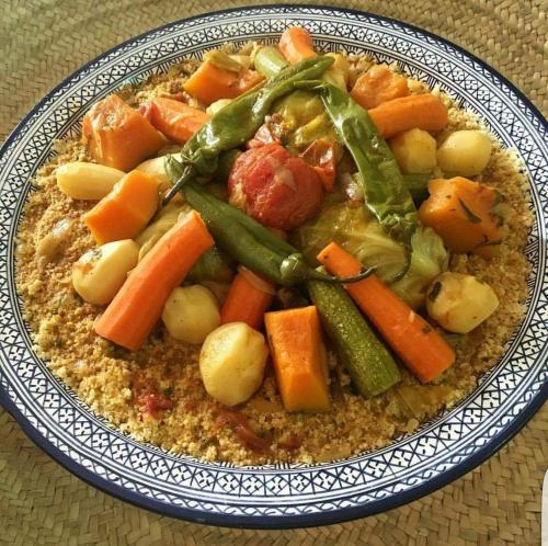 a plate of food with vegetables on a table at Auberge la belle vue dades in Akhendachou nʼAït Ouffi