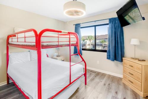 a bedroom with two bunk beds and a window at Beachwalk Condominiums 6F in Panama City Beach