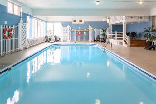 a large swimming pool with blue water in a building at Rodd Charlottetown in Charlottetown