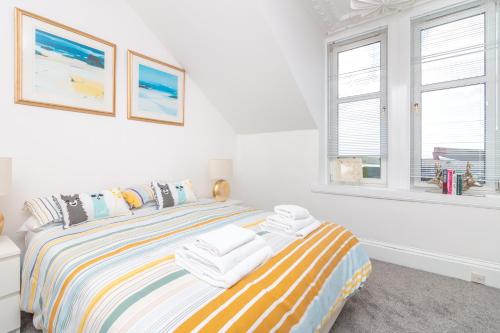 a bedroom with a bed with towels on it at Bridgeview in Dundee