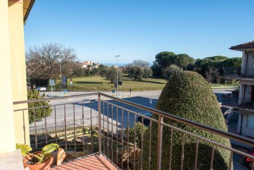 a view from a balcony of a building with a large bush at N247 - Numana, meraviglioso quadrilocale in posizione strategica in Numana