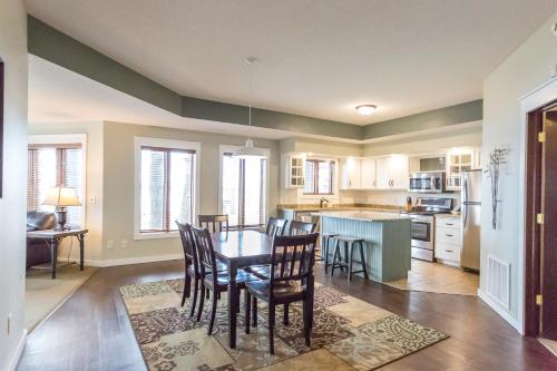 a kitchen and dining room with a table and chairs at Bay Colony- Unit 764 - Lower in Nisswa