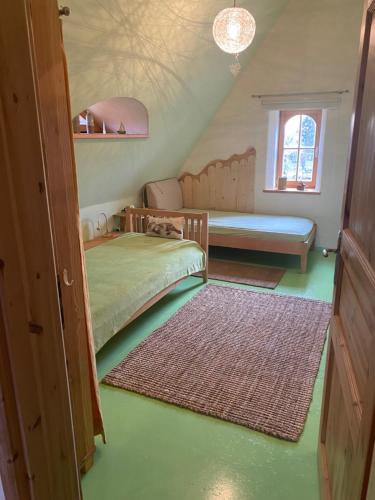 a attic room with a bed and a window at Sonnenhof Muldental in Colditz