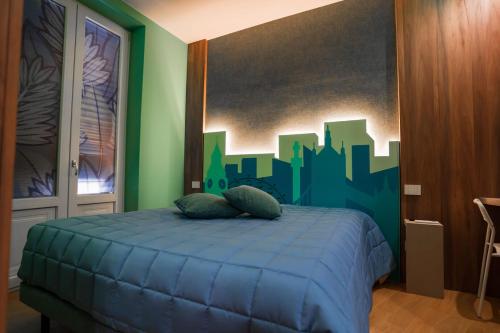 a bedroom with a bed with a city mural on the wall at Grantò B&B in Gravina in Puglia