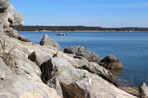 a boat on a large body of water with rocks at Canyon Lakeview Resort in Canyon Lake