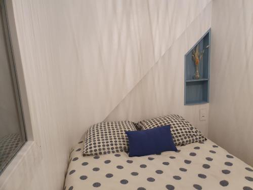 uma cama com duas almofadas num quarto em La Perle Bleue em Dieppe