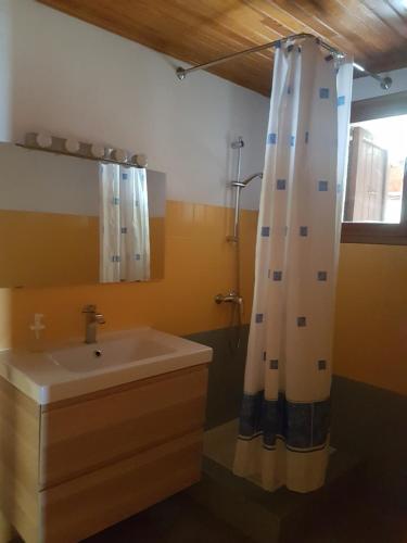 a bathroom with a sink and a mirror at La Maison de Joséphine in Risoul