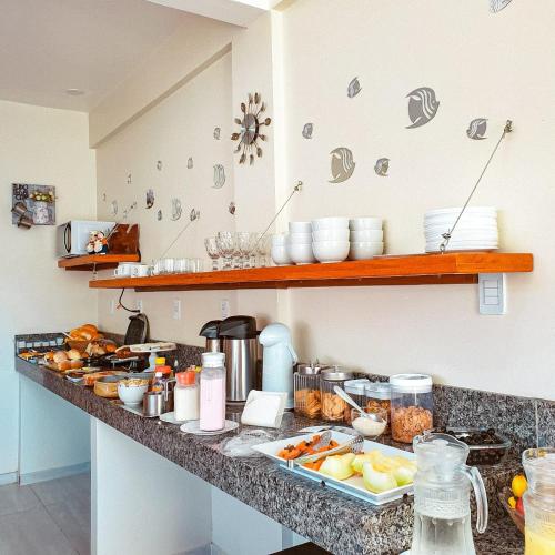 a kitchen counter with a bunch of food on it at Pousada Cantinho da Praia in Paraty