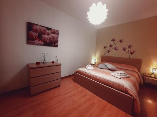 a bedroom with a bed and a dresser and a lamp at Relax Home in Bari