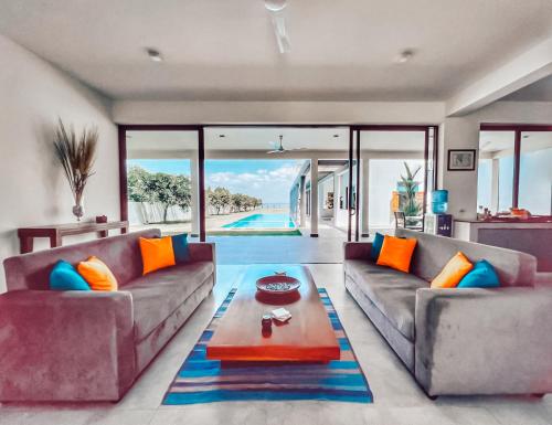 a living room with two couches and a table at Villa Lagoonscape in Negombo