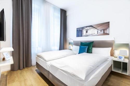 a bedroom with two beds and a large window at Ferienapartments am Krusespeicher Ferienapartments am Krusespeicher 2-16 in Wismar