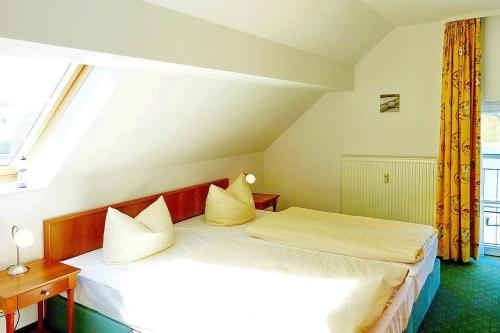 a bedroom with two beds and a window at Seehof Seehof 41 in Bansin