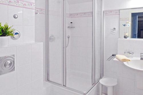 a white bathroom with a shower and a sink at Seehof Seehof 41 in Bansin