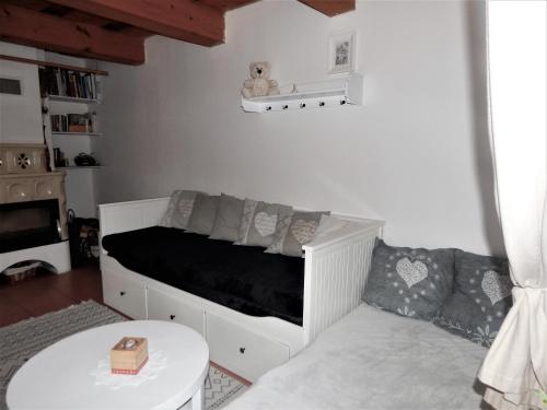 a room with a bed with a couch and a table at Chalúpka u Fulov in Bziny