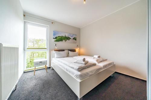 Voodi või voodid majutusasutuse NordseeResort Friesland NordseeResort Friesland 52-2-N toas