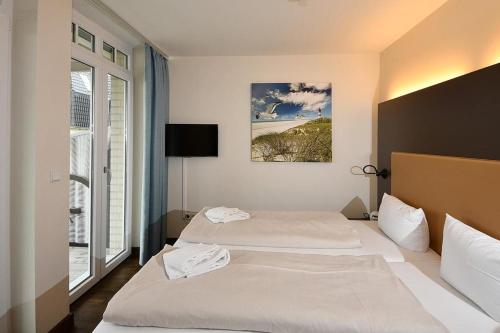Кровать или кровати в номере Resort Deichgraf Resort Deichgraf 31-11