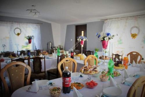 ein Esszimmer mit einem Tisch mit Essen drauf in der Unterkunft Domek na skraju lasu in Dąbrowa Górna