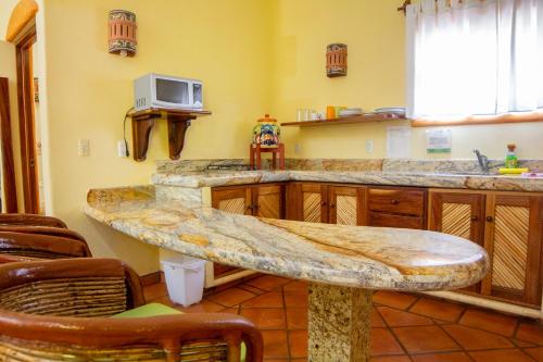 a kitchen with a stone counter top and a sink at Bungalows Jaqueline in Sayulita