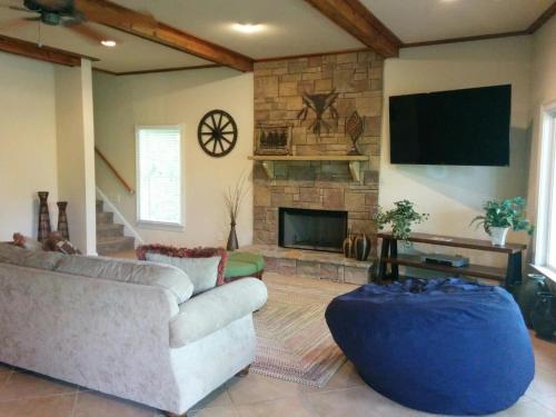 a living room with a couch and a fireplace at Lake views galore from balconies right on the lake and drought-proof deep water in Murrayville