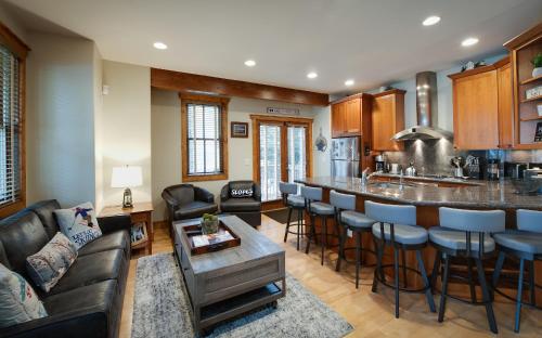 a living room with a bar and a kitchen at Ridge Street Chalet Home: Historic District Charm in Breckenridge